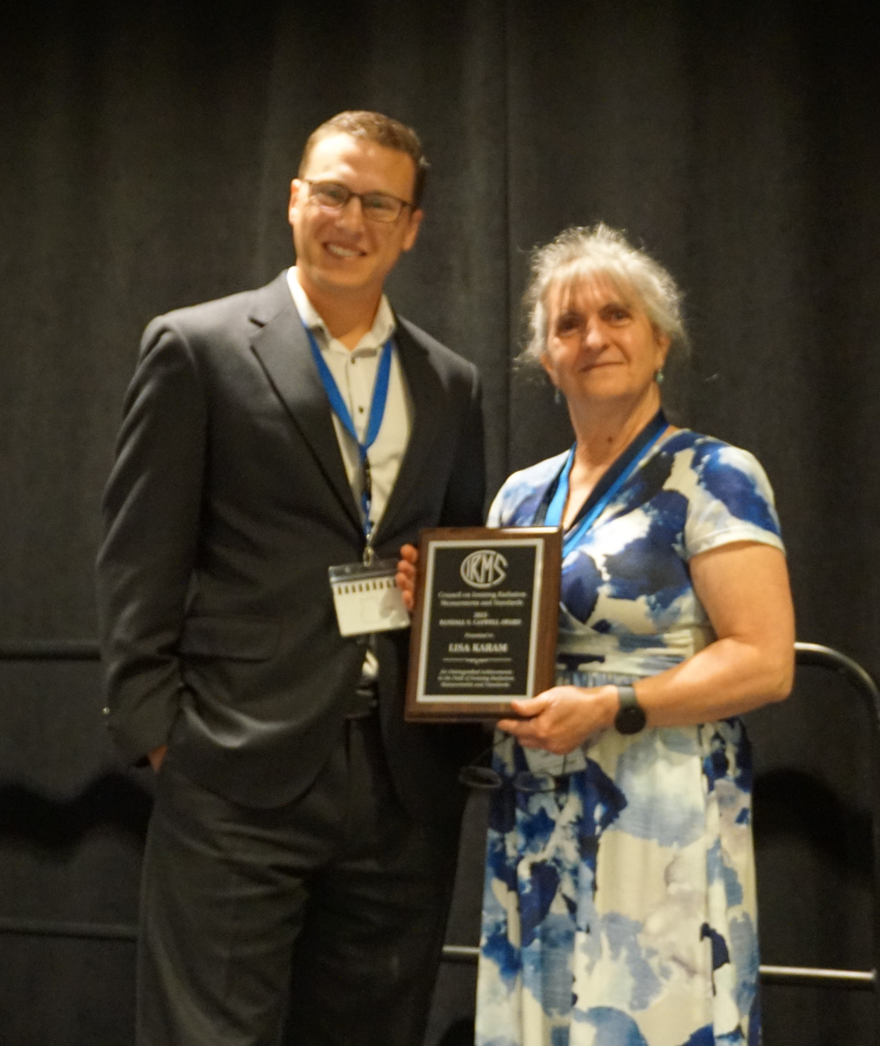 Dr Karam receiving the Randall S. Caswell Award from Spencer Mickum, CIRMS former President.